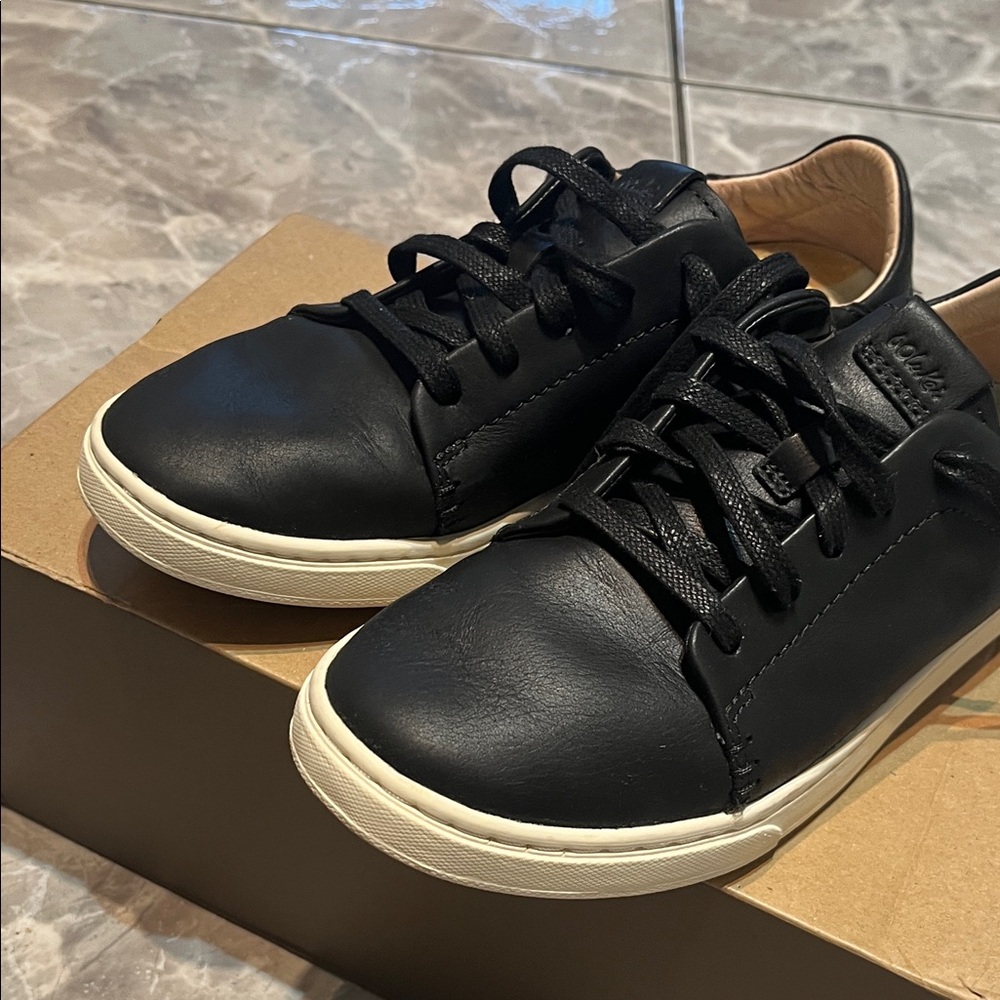 OluKai  Women Black Leather Sneakers with Cream sole.